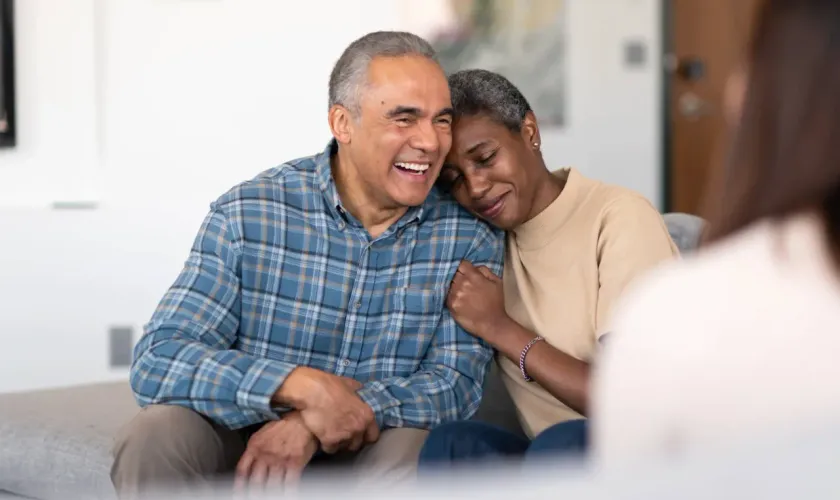 An older couple sharing a warm, comforting moment together at home